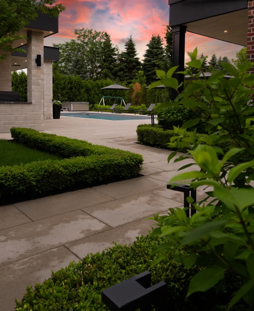 A gorgeous pool coping, flag stone and natural stone installation project completed by Mutti Landscaping