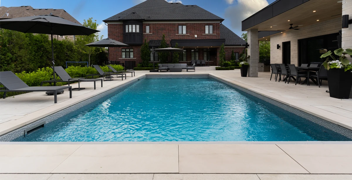 A gorgeous pool coping, flag stone and natural stone installation project completed by Mutti Landscaping