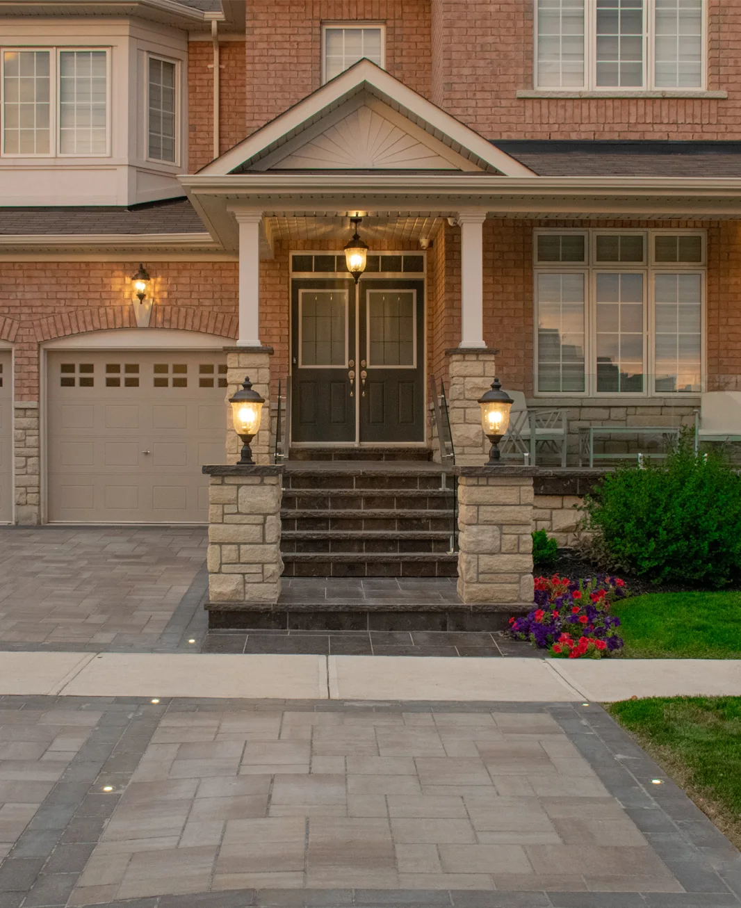 Pillars and walls and custom lighting installed by Mutti Landscaping for a customer's home in Ontario