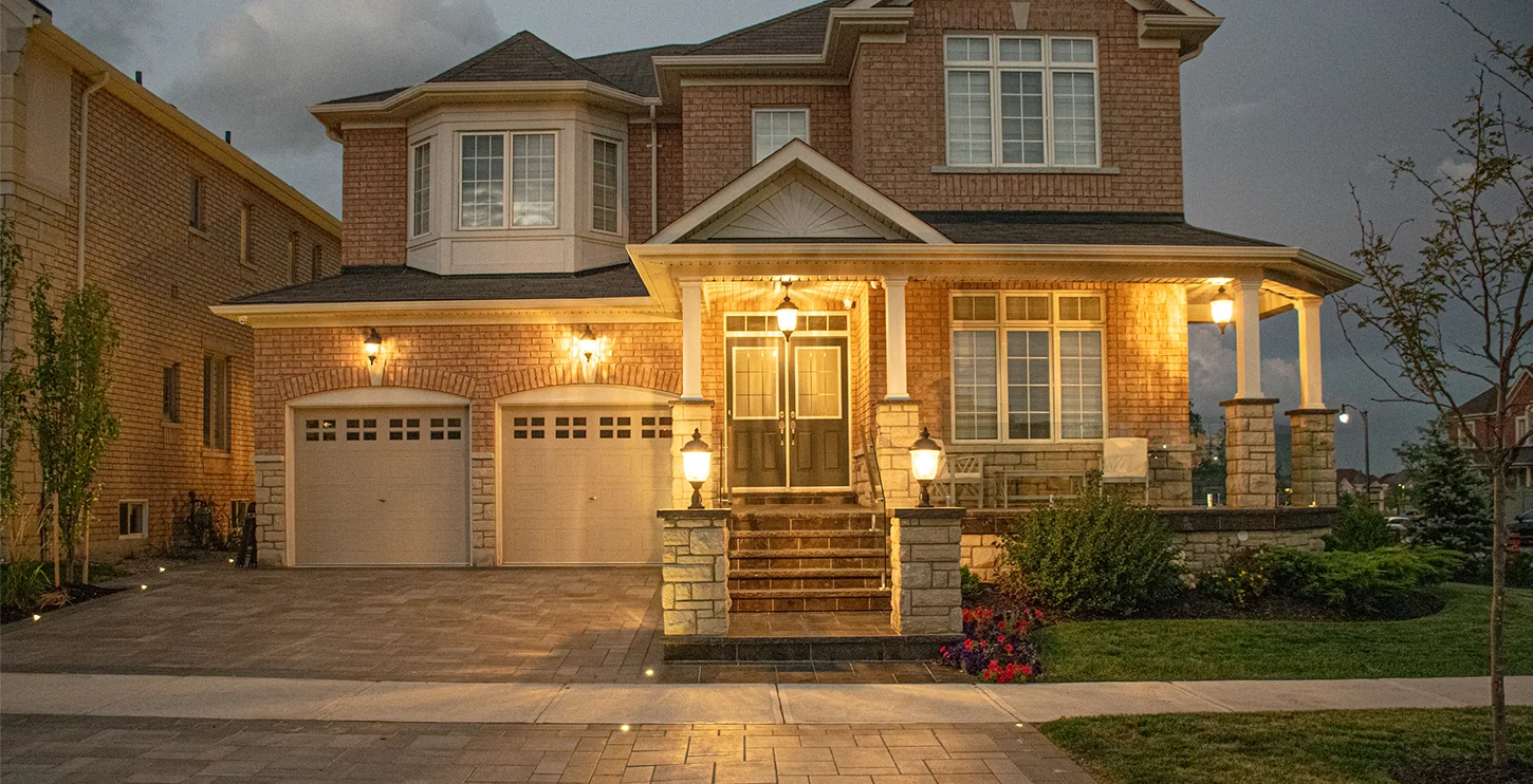 Pillars and walls and custom lighting installed by Mutti Landscaping for a customer's home in Ontario