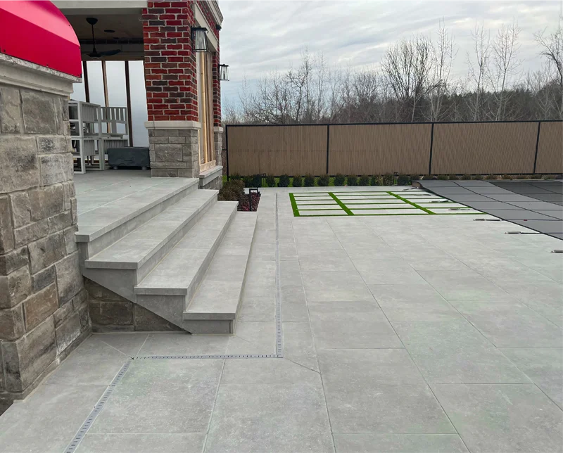 A backyard porcelain patio installed by Mutti Landscaping in the GTA