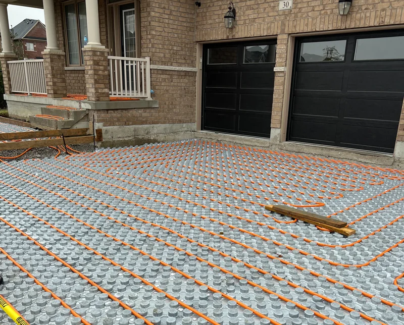 A heated driveway installation project by Mutti Landscaping with the underwiring being shown