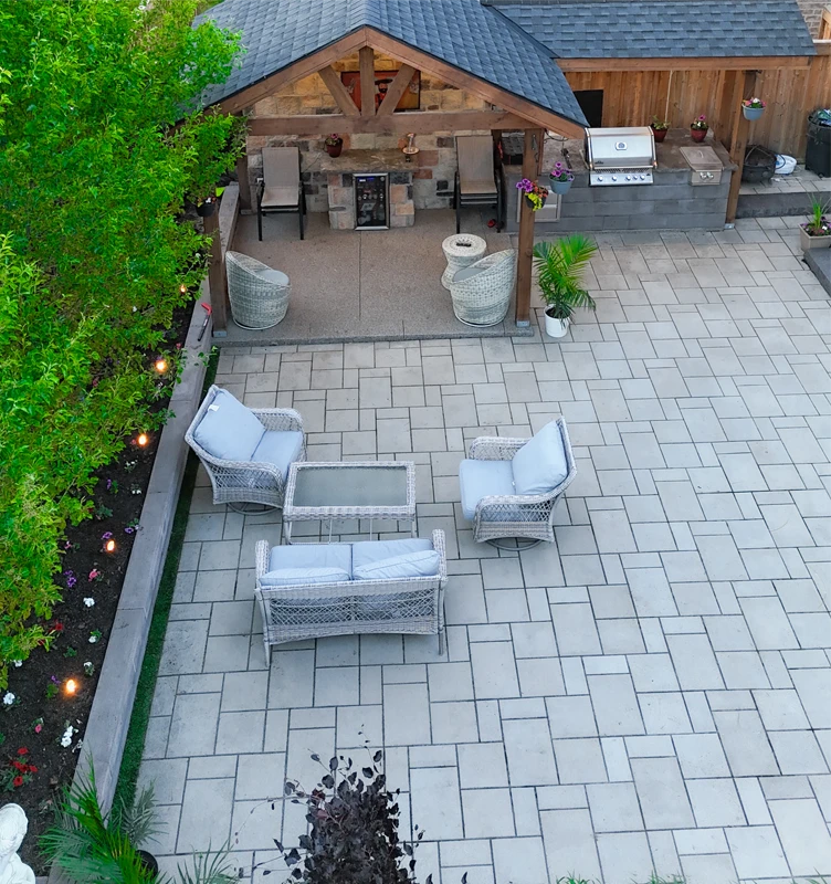 An outdoor kitchen / barbeque with an interlocking patio installed by Mutti Landcaping